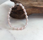 Natural freshwater pearl bracelet in a soft pale pink tone with bright mirror luster.