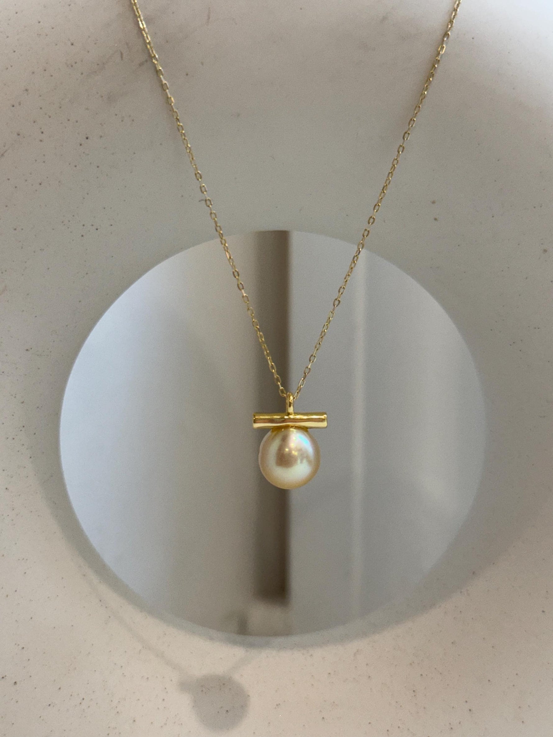 Minimalist 10mm golden pearl pendant with beautiful high luster and contemporary style.