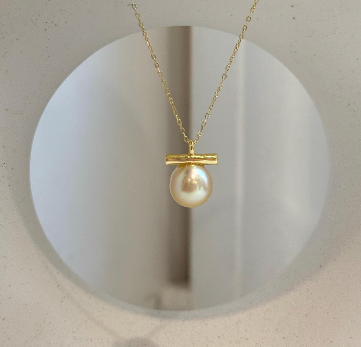 Genuine South Sea golden pearl pendant featuring a unique modern balancing design.