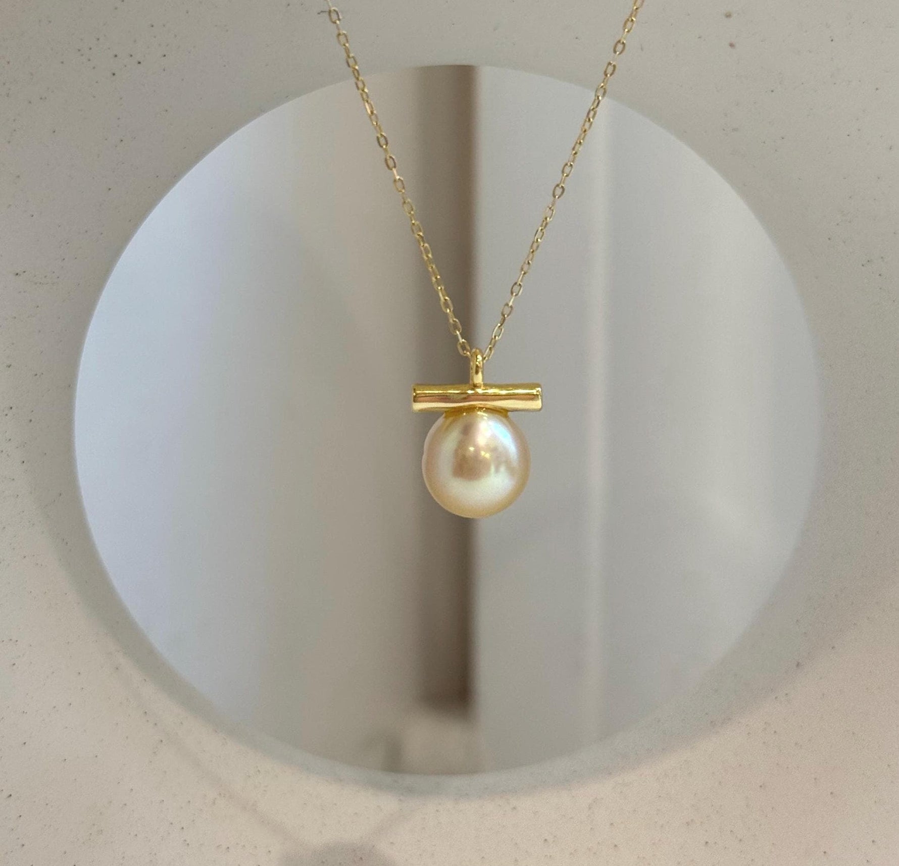 Genuine South Sea golden pearl pendant featuring a unique modern balancing design.