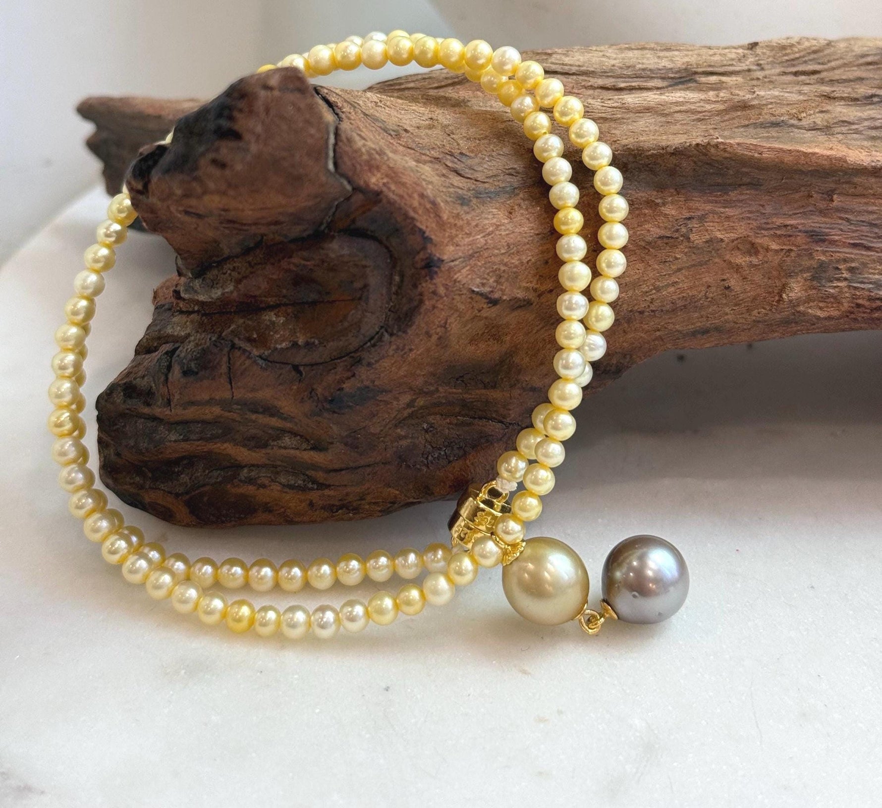 Unique multicolor pearl pendant necklace featuring genuine saltwater and freshwater pearls.