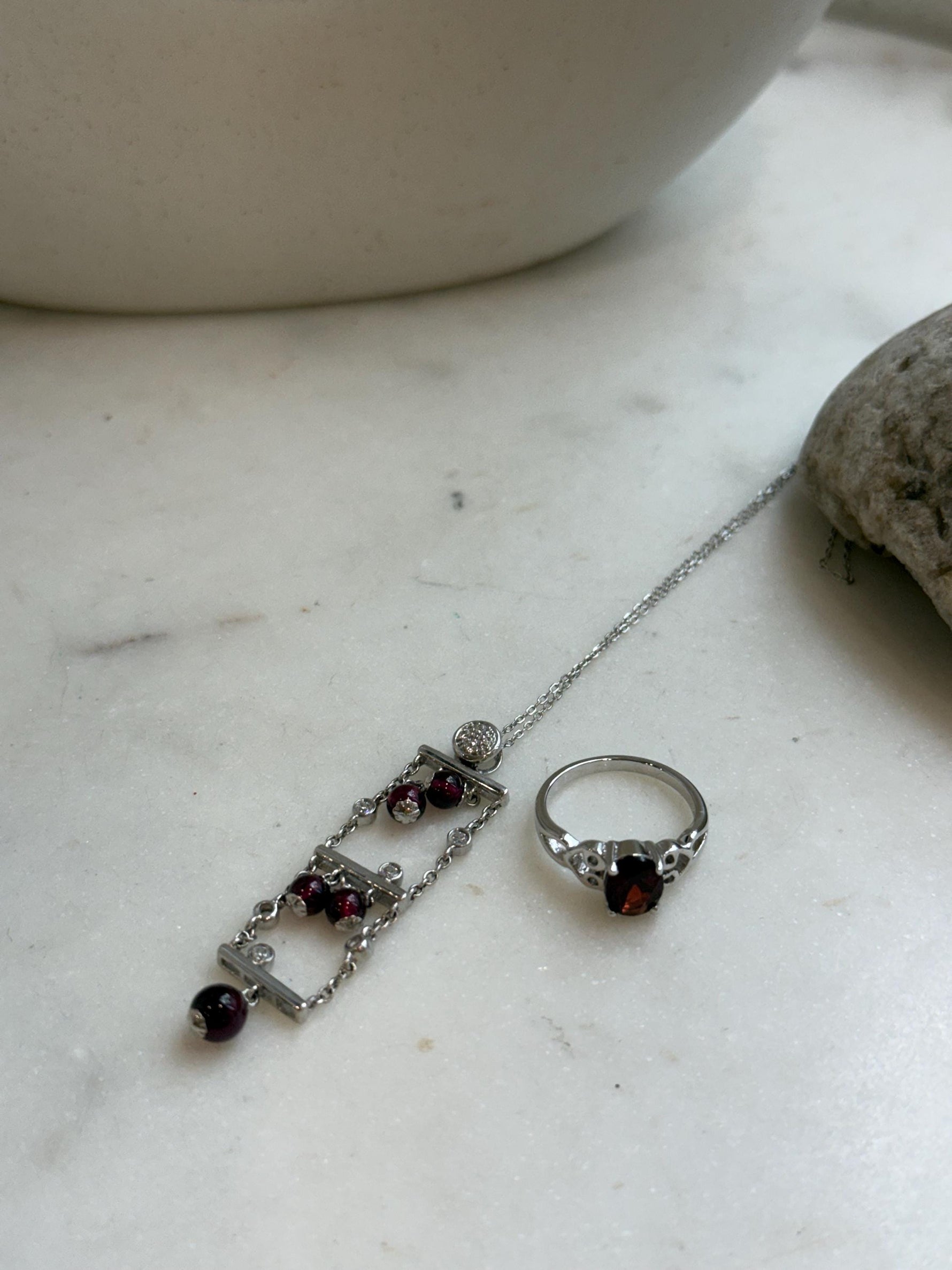 Elegant red gemstone pendant and ring set featuring natural garnet