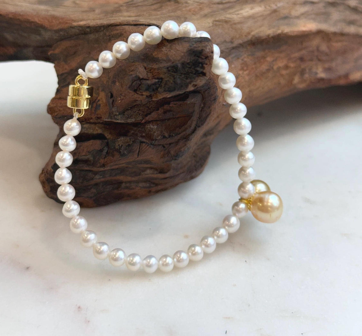 Genuine South Sea golden pearl bracelet featuring two luminous 8.5–8.8mm pearls.