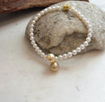Genuine saltwater pearl bracelet with lustrous South Sea golden pearls and polished sterling silver details.