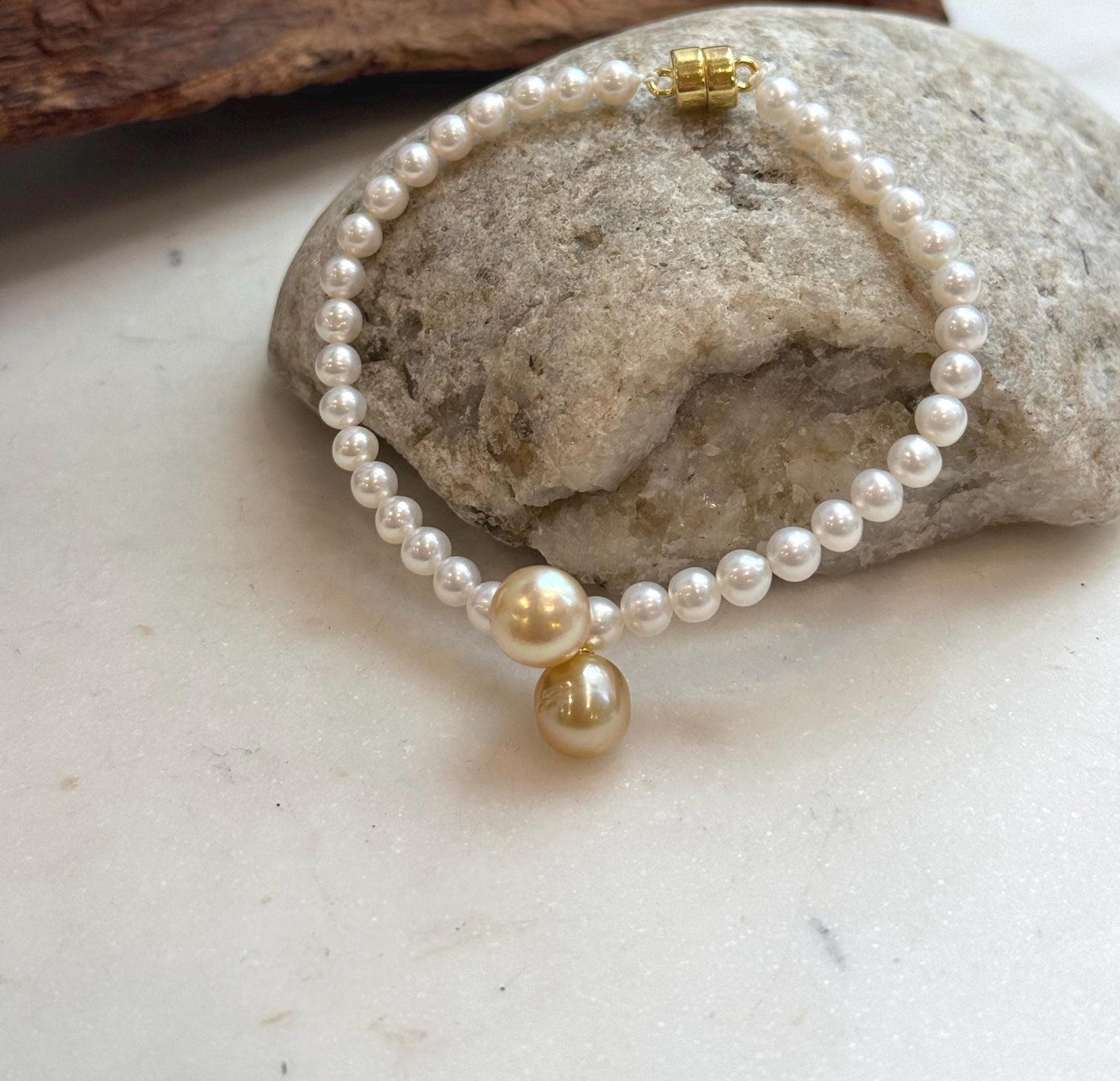 Genuine saltwater pearl bracelet with lustrous South Sea golden pearls and polished sterling silver details.