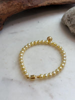 Natural 7.6mm golden saltwater pearls showing their rich color and luminous surface.
