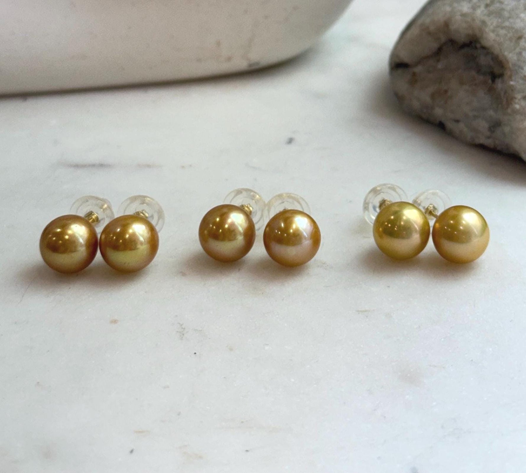 Genuine Edison freshwater pearl studs featuring luminous golden pearls and sterling silver posts.