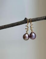 Genuine Edison freshwater pearl earrings featuring beautiful rose lavender tones.
