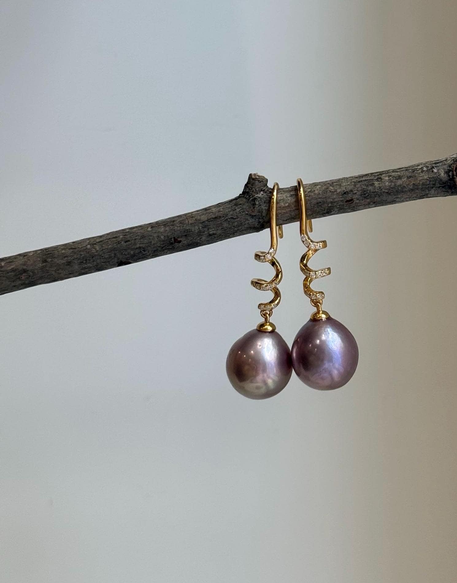 Genuine Edison freshwater pearl earrings featuring beautiful rose lavender tones.