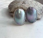 Large ocean Mabe pearl earrings with luminous blue iridescent tones