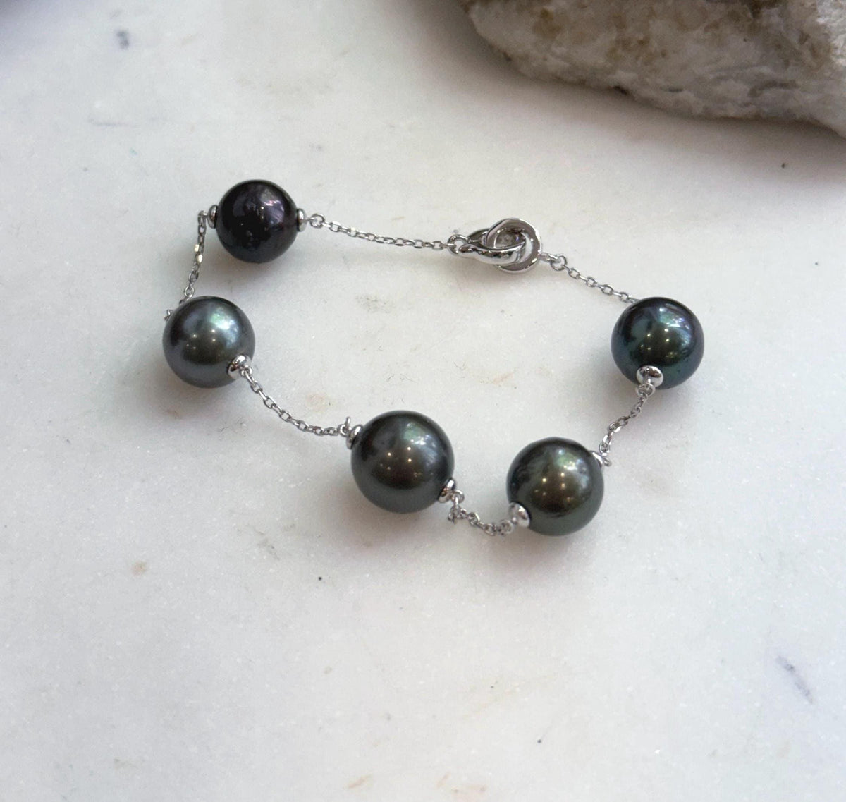 Five 10.2–10.8mm Tahitian ocean pearls on delicate silver chain