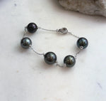 Five 10.2–10.8mm Tahitian ocean pearls on delicate silver chain
