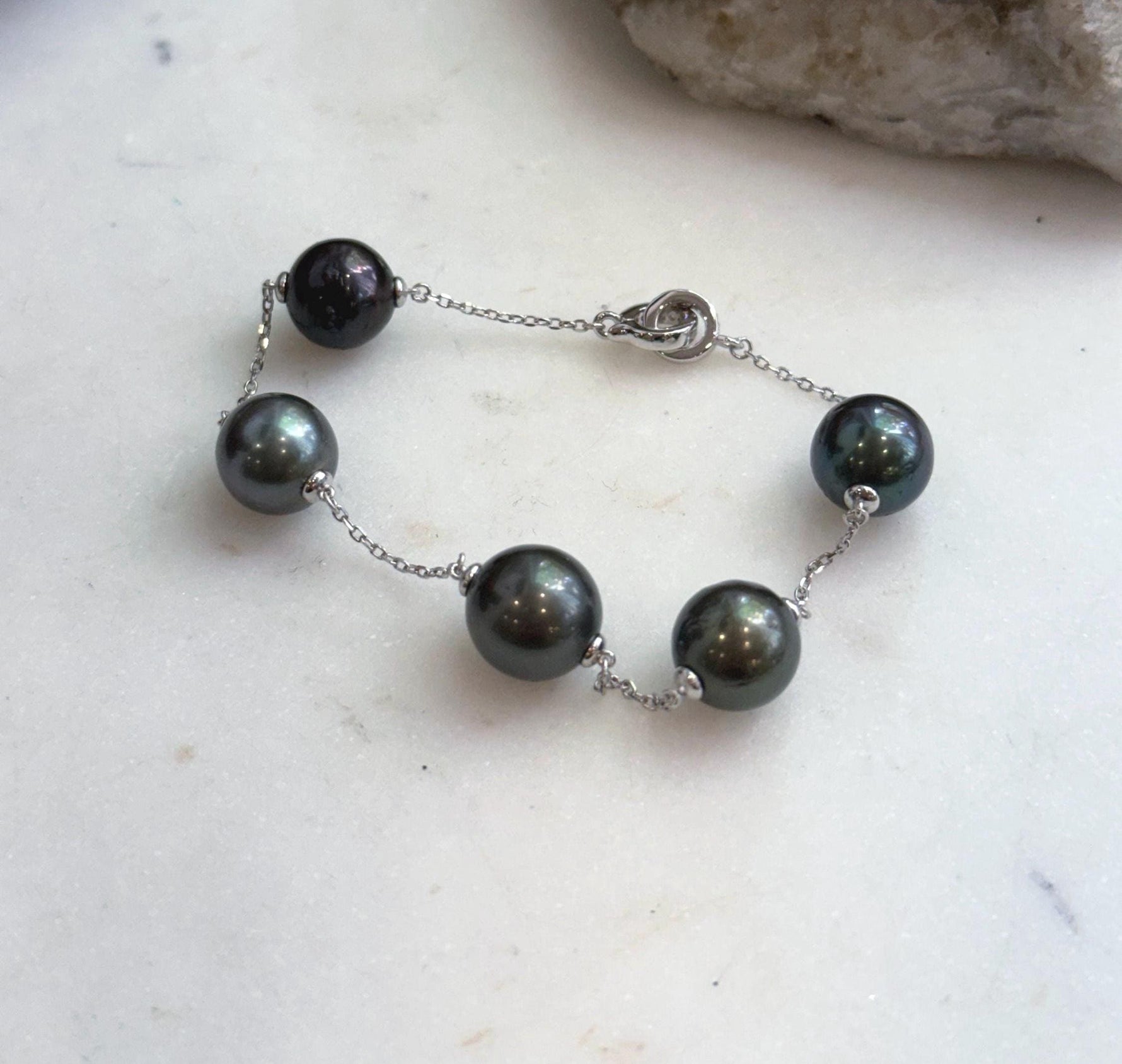 Five 10.2–10.8mm Tahitian ocean pearls on delicate silver chain