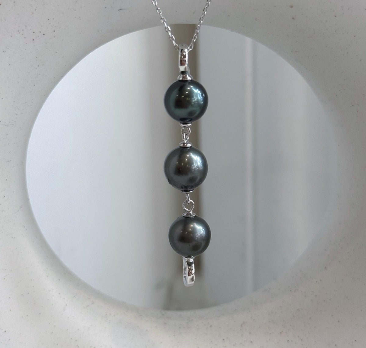Three Tahitian pearls with mirror-like metallic luster