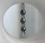 Three Tahitian pearls with mirror-like metallic luster