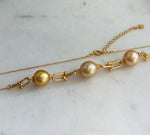 Golden pearl satellite necklace featuring three naturally elegant South Sea pearls