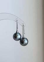 Cool platinum Tahitian pearl earrings with modern fancy hooks
