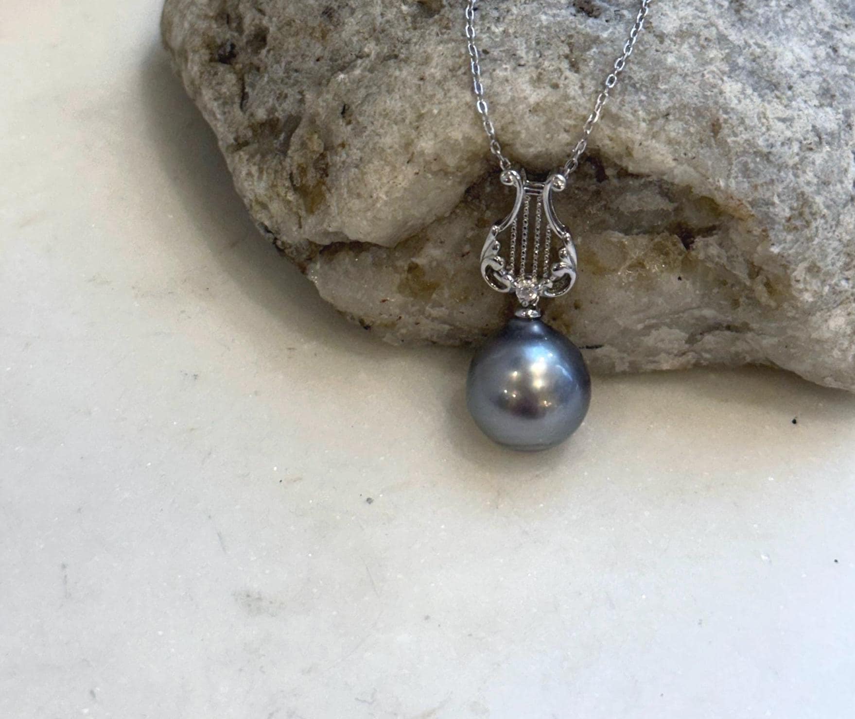 Genuine saltwater pearl pendant in sterling silver lyre design