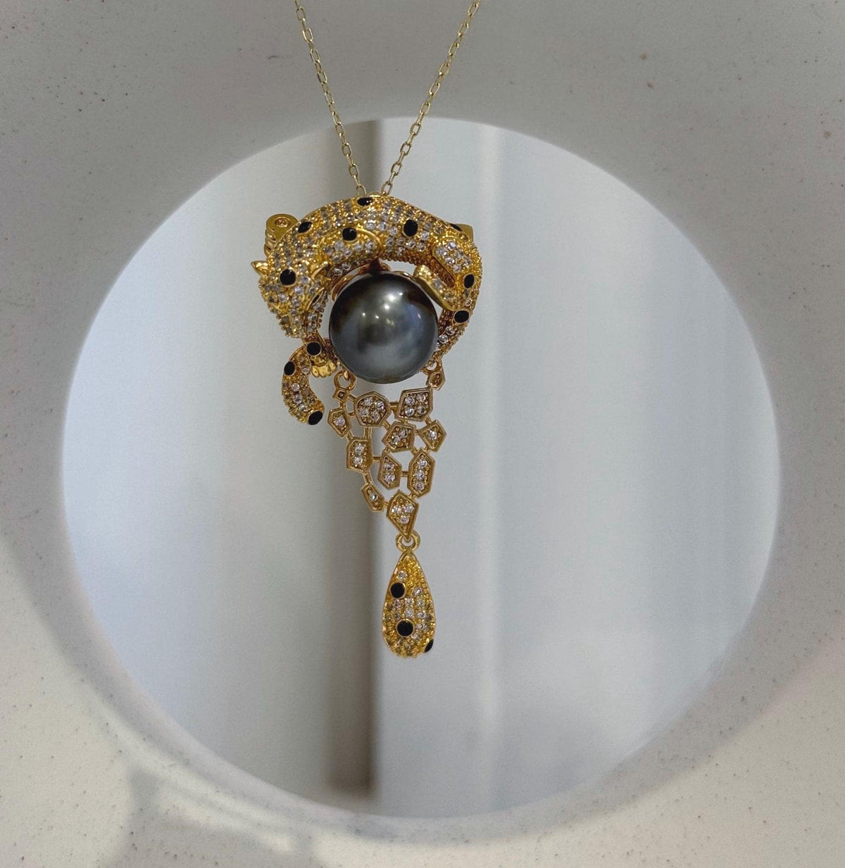 Vintage leopard brooch with lustrous 10.7mm Tahitian platinum pearl centerpiece.