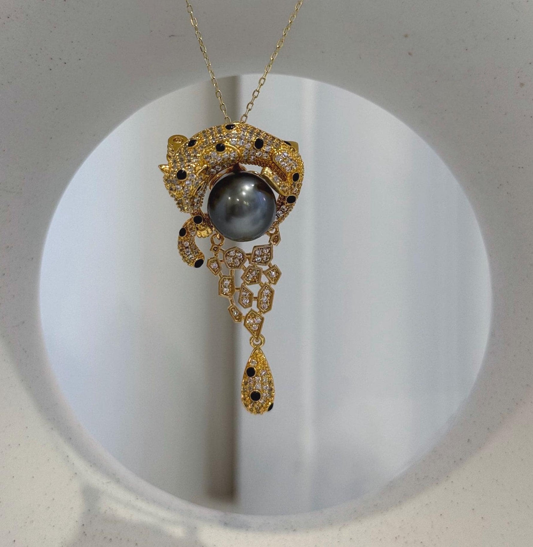 Vintage leopard brooch with lustrous 10.7mm Tahitian platinum pearl centerpiece.