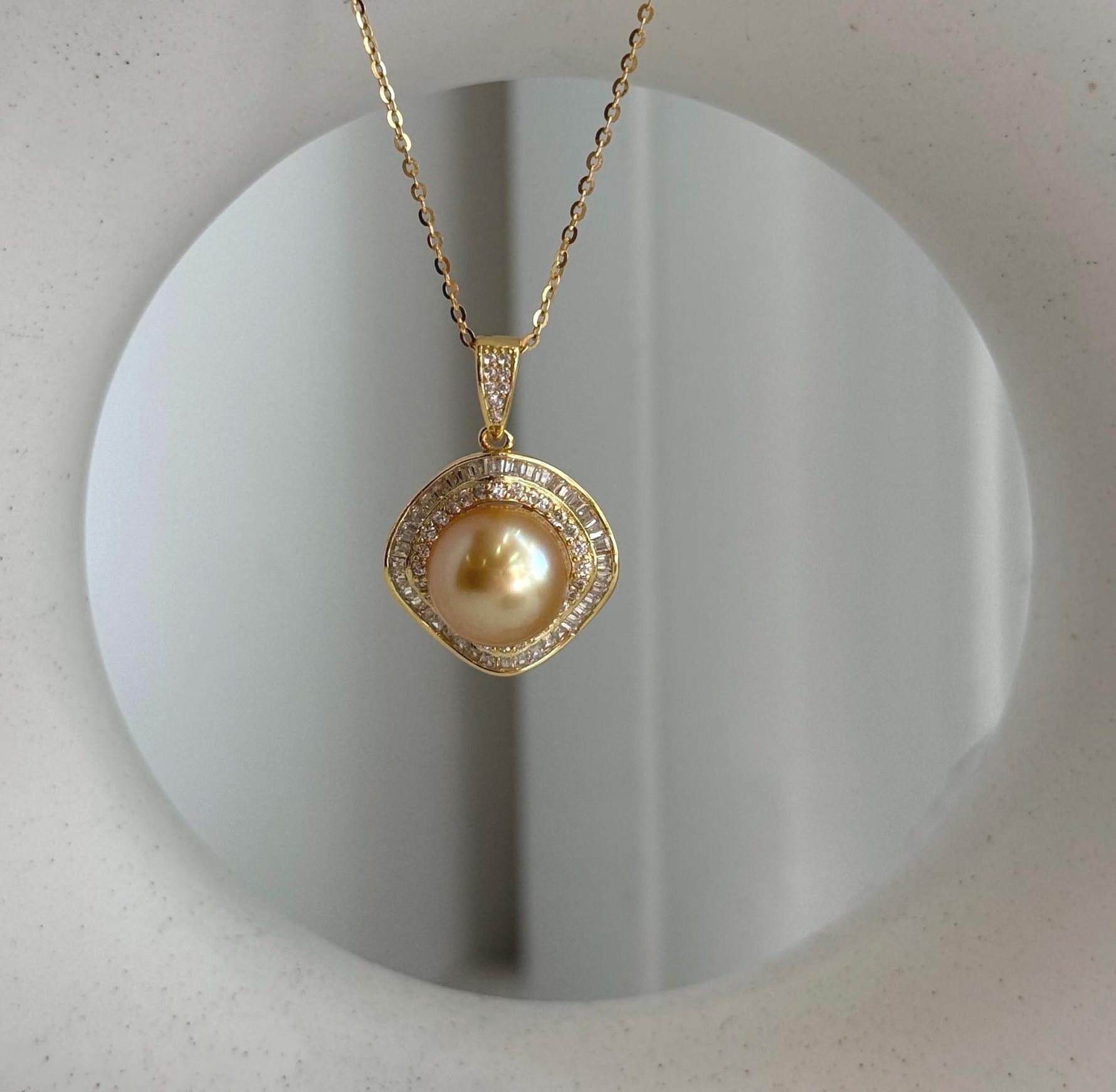 Genuine saltwater pearl pendant featuring a deep tea gold tone and elegant setting