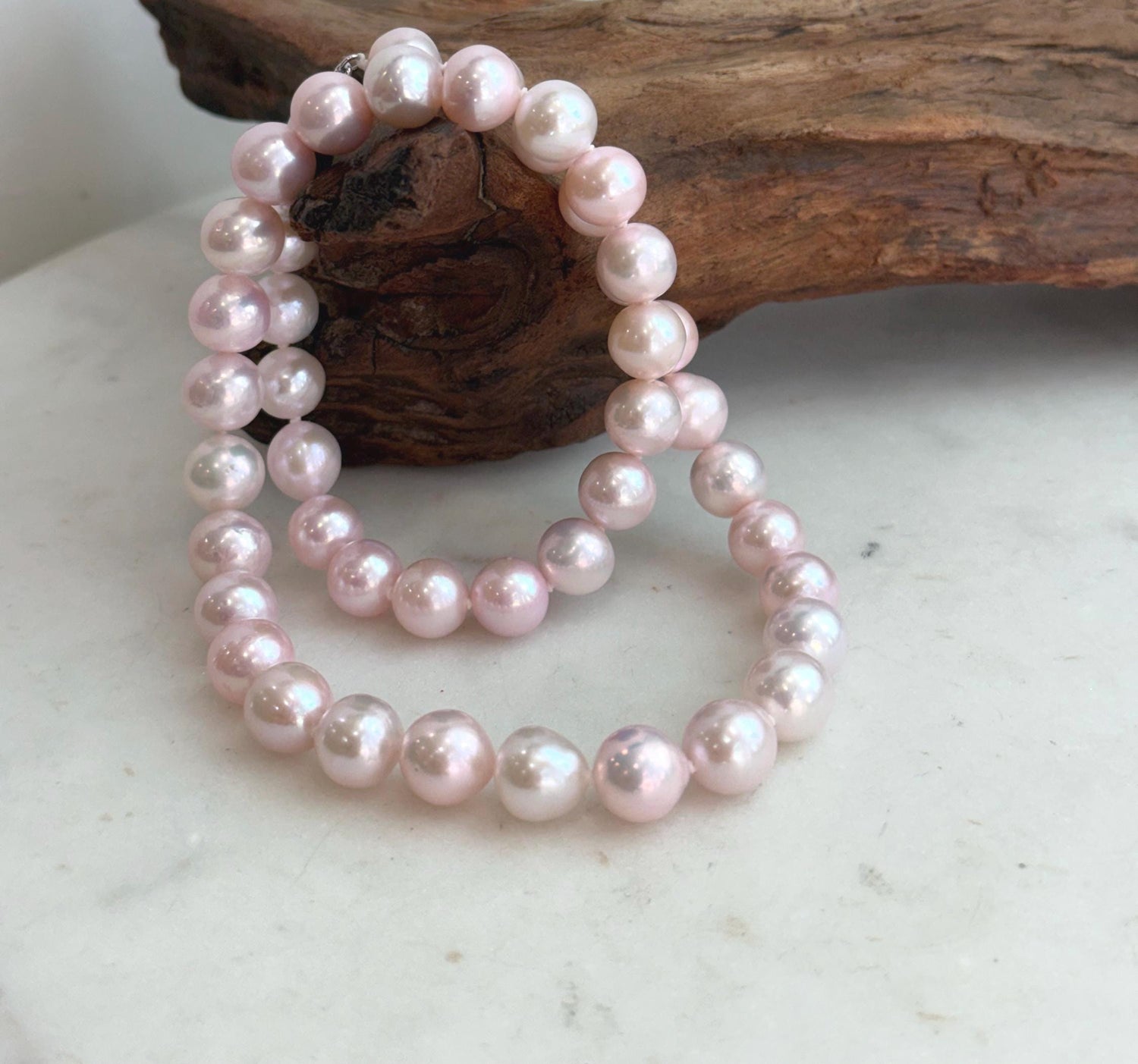 Pale pink freshwater pearl necklace featuring 44 genuine 9–10mm pearls with extreme mirror luster.
