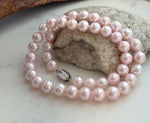 Elegant 17.8-inch genuine pearl necklace with 9–10mm pale pink pearls and extreme mirror luster.