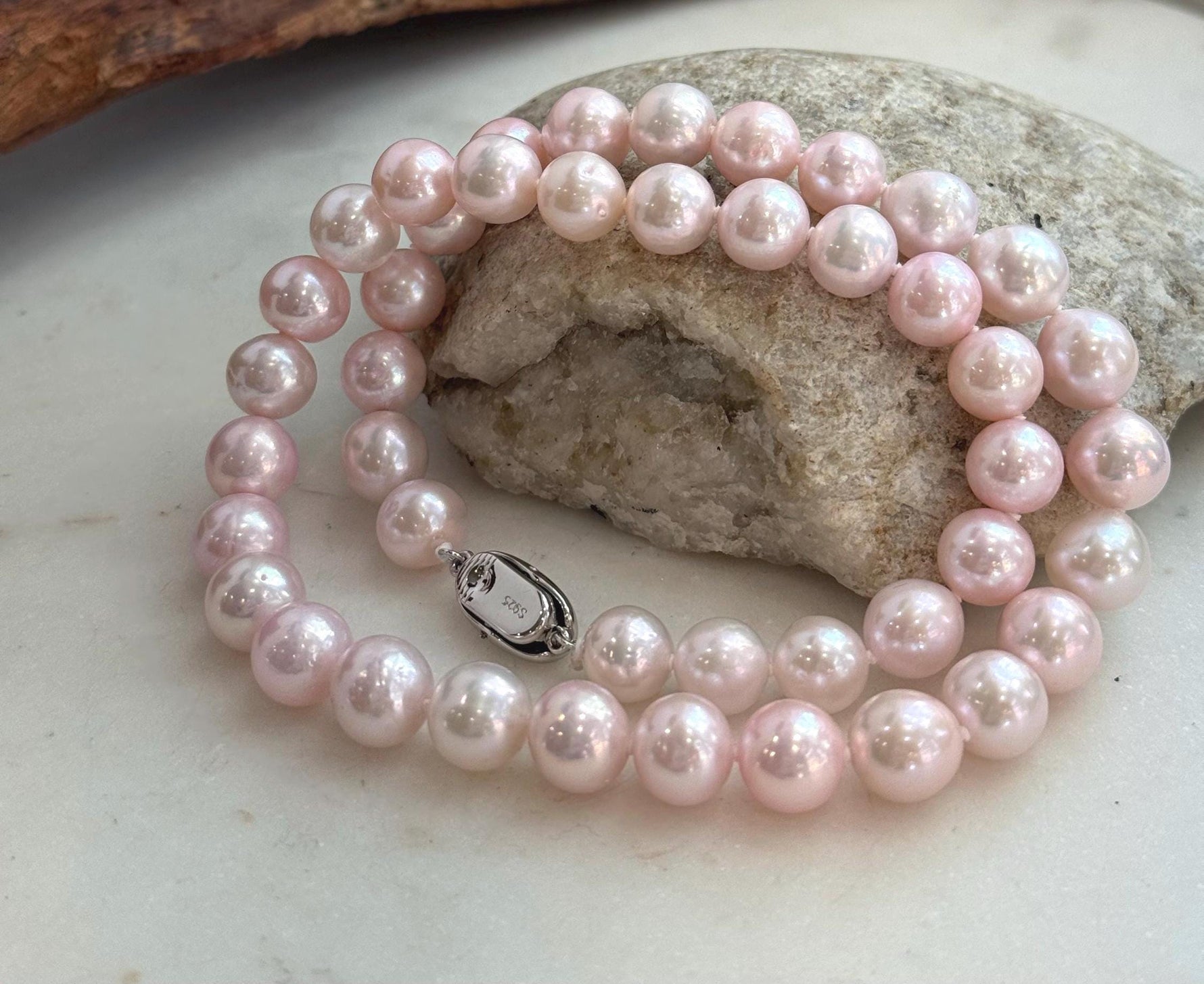 Elegant 17.8-inch genuine pearl necklace with 9–10mm pale pink pearls and extreme mirror luster.