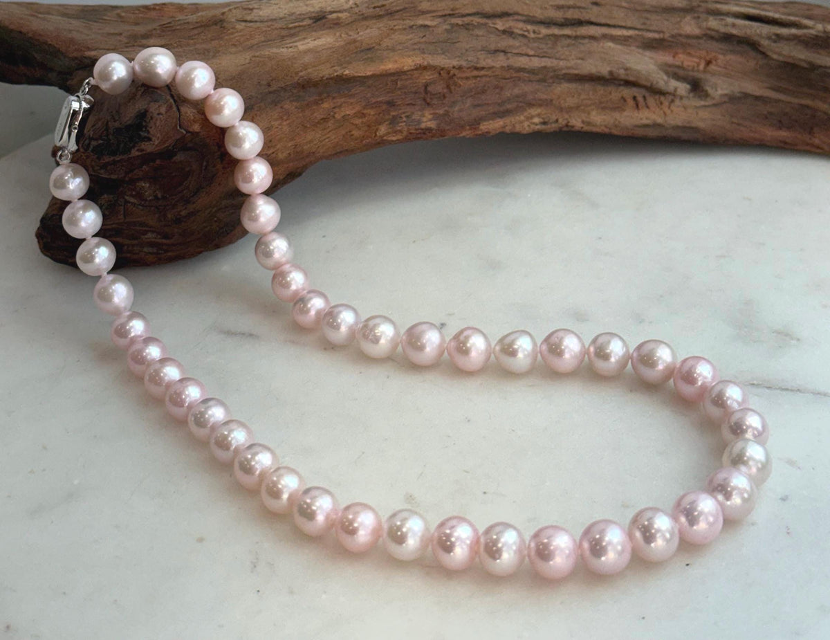 Elegant 17.8-inch genuine pearl necklace with 9–10mm pale pink pearls and extreme mirror luster.
