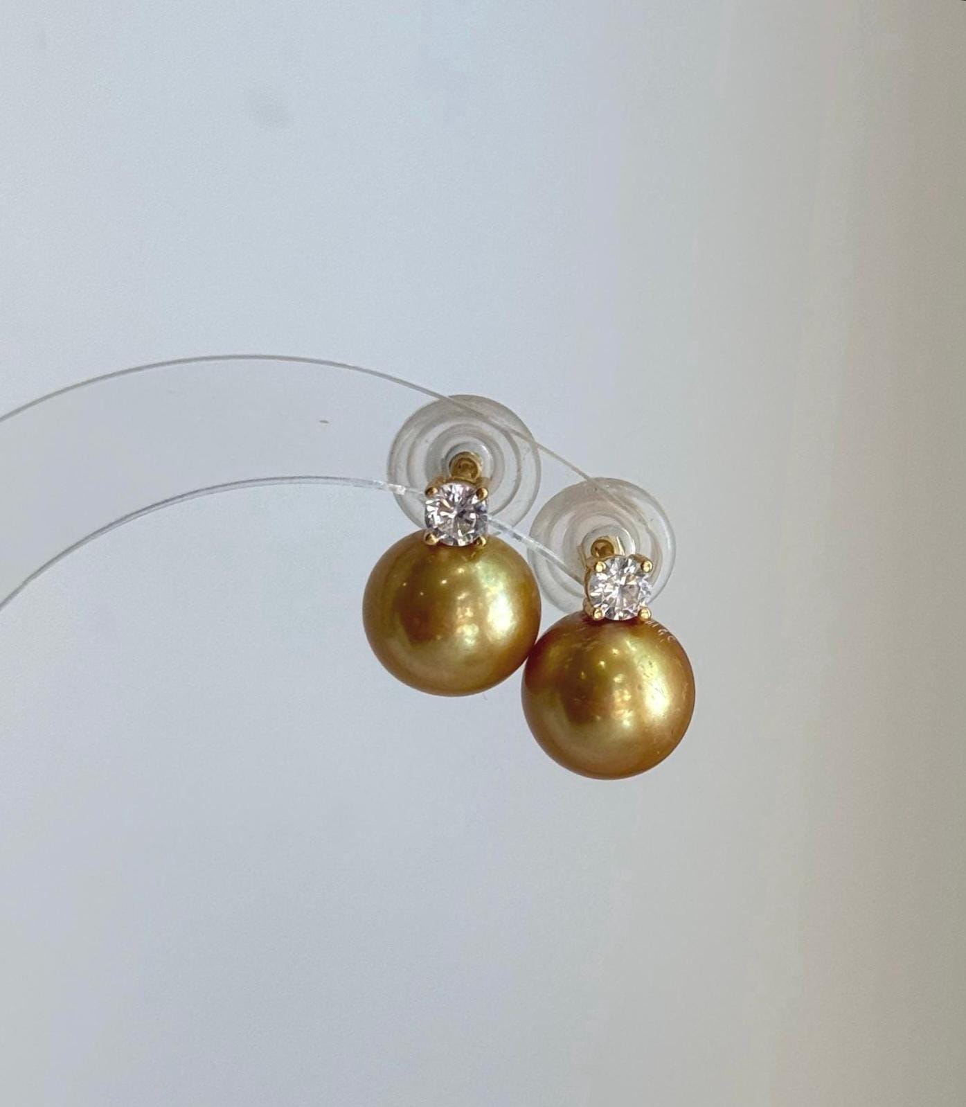 Genuine 11.3mm Edison golden pearl earrings featuring beautiful reflective mirror luster.