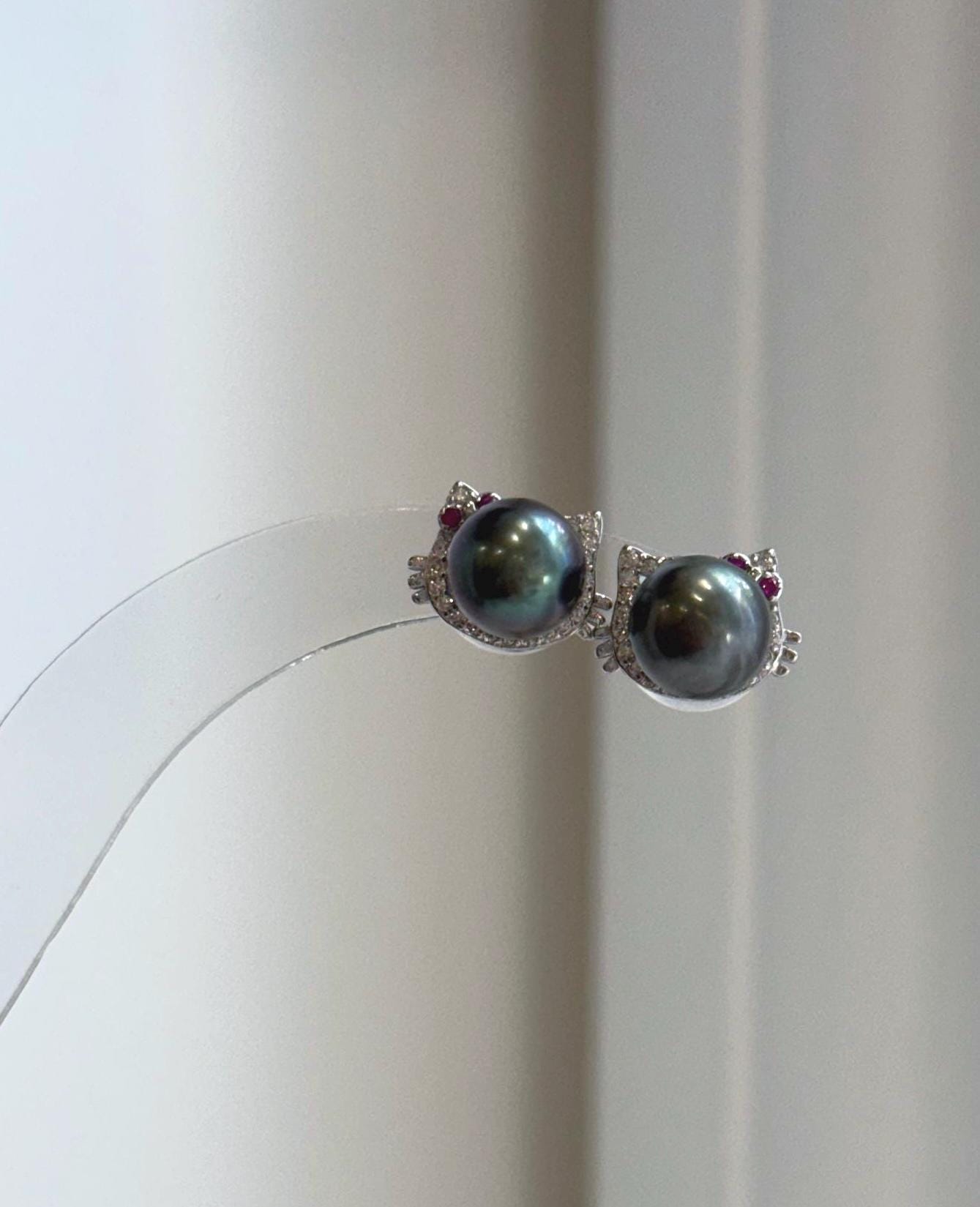 Genuine Tahitian saltwater pearl cat earrings featuring rich peacock hunter tones and brilliant mirror luster.