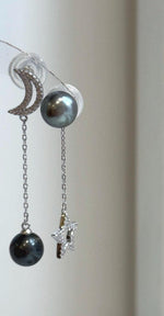 Genuine Tahitian ocean pearl earrings featuring platinum hunter tones with celestial star and moon design