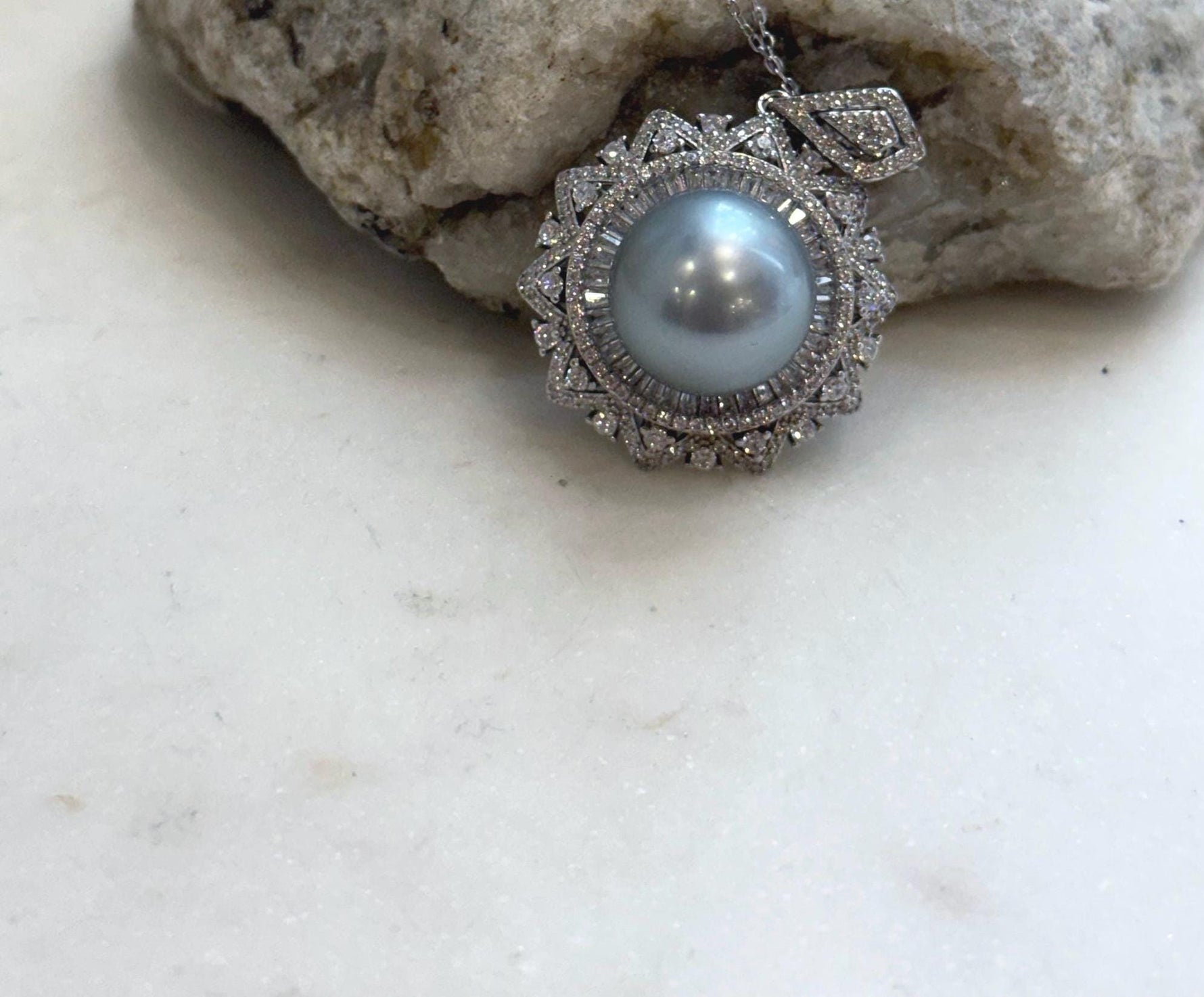 Genuine Tahitian silver saltwater pearl pendant featuring rare large size and brilliant reflective luster.