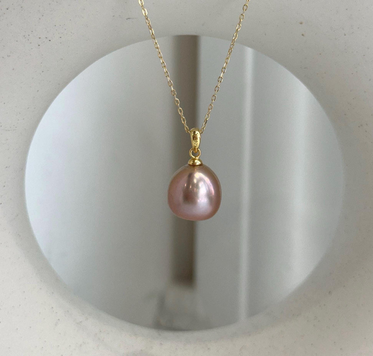 Luxury rose gold Edison pearl necklace pendant with brilliant reflective luster.