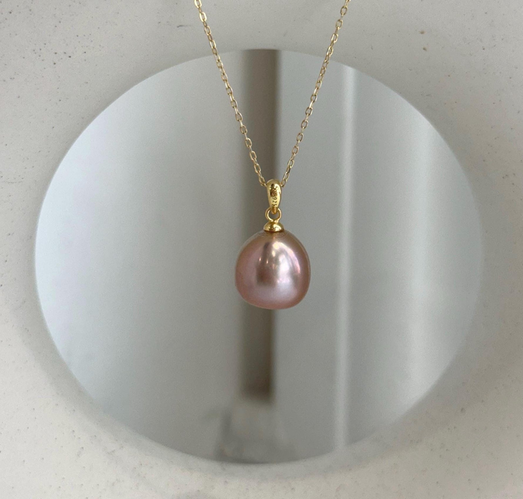Luxury rose gold Edison pearl necklace pendant with brilliant reflective luster.