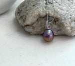 Extreme mirror luster freshwater pearl pendant with distinctive rose purple golden coloration.