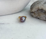 Genuine freshwater Edison pearl jewelry featuring a bright reflective surface and elegant silver ring design.