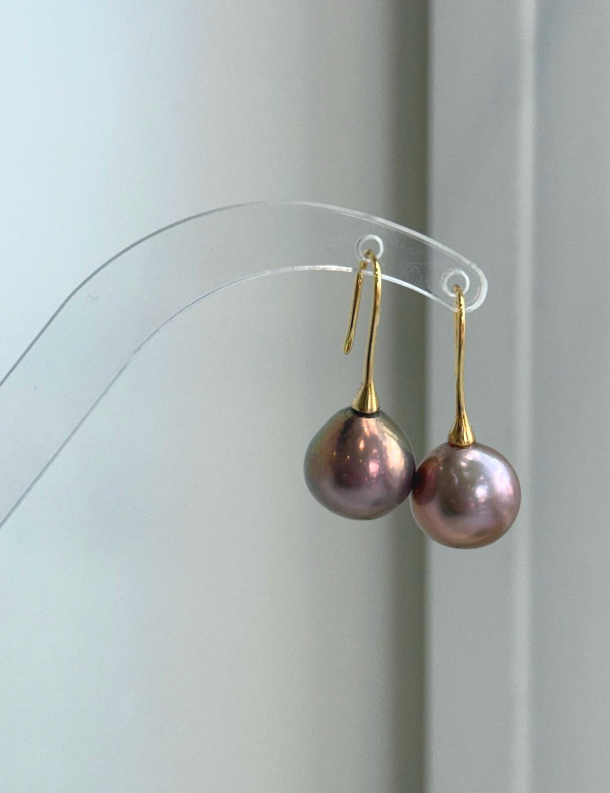 Genuine freshwater Edison pearl earrings featuring 12.6mm rose gold green pearls with beautiful color overtones.