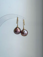 Close-up of 12.6mm Edison pearls showing unique rose gold green tones and extremely reflective luster.