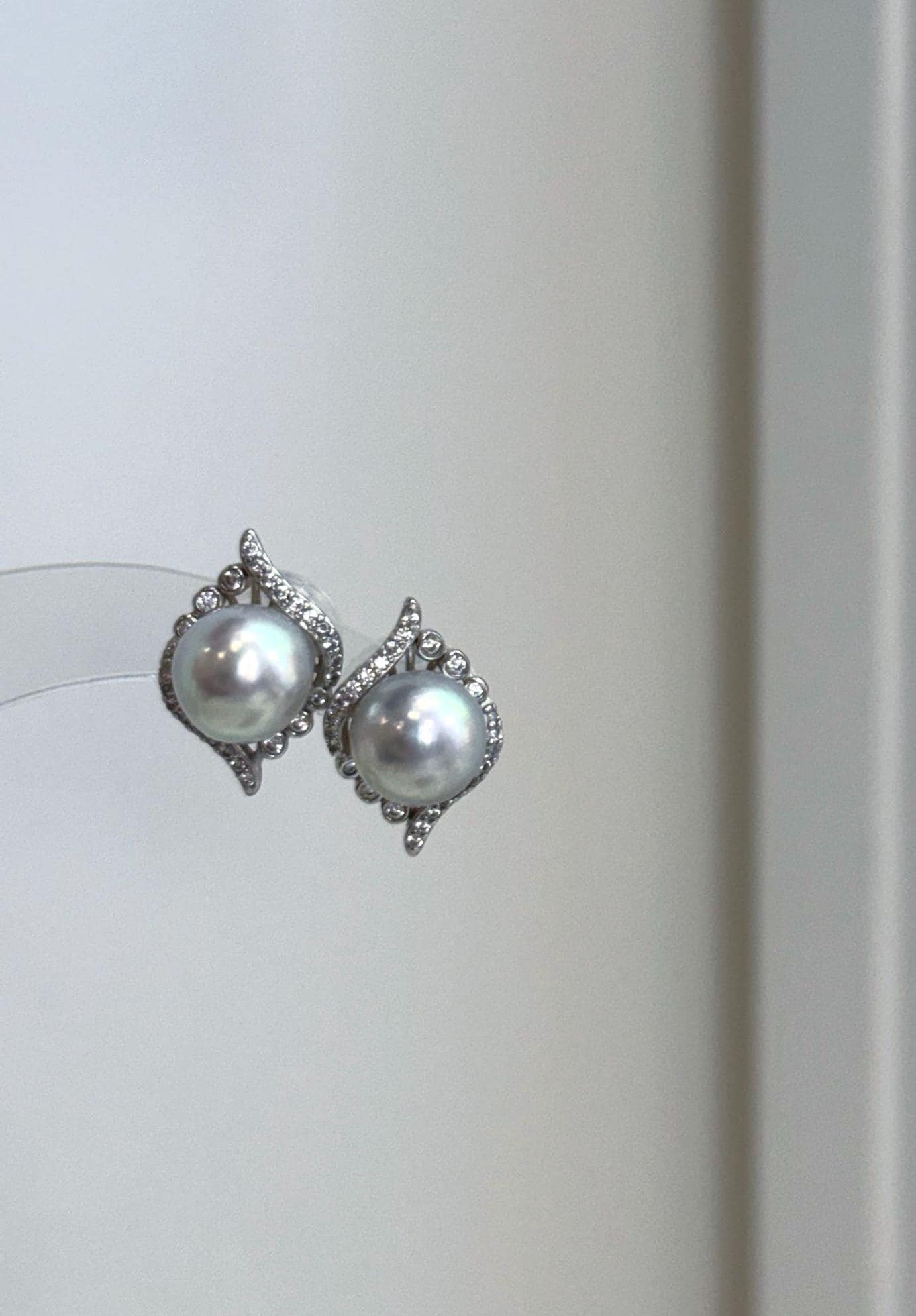 Genuine saltwater Akoya pearl earrings featuring rare ocean blue silver tones and brilliant reflective luster.