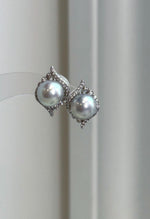 Genuine ocean blue Akoya saltwater pearl earrings with cool silver overtones and luminous mirror luster.