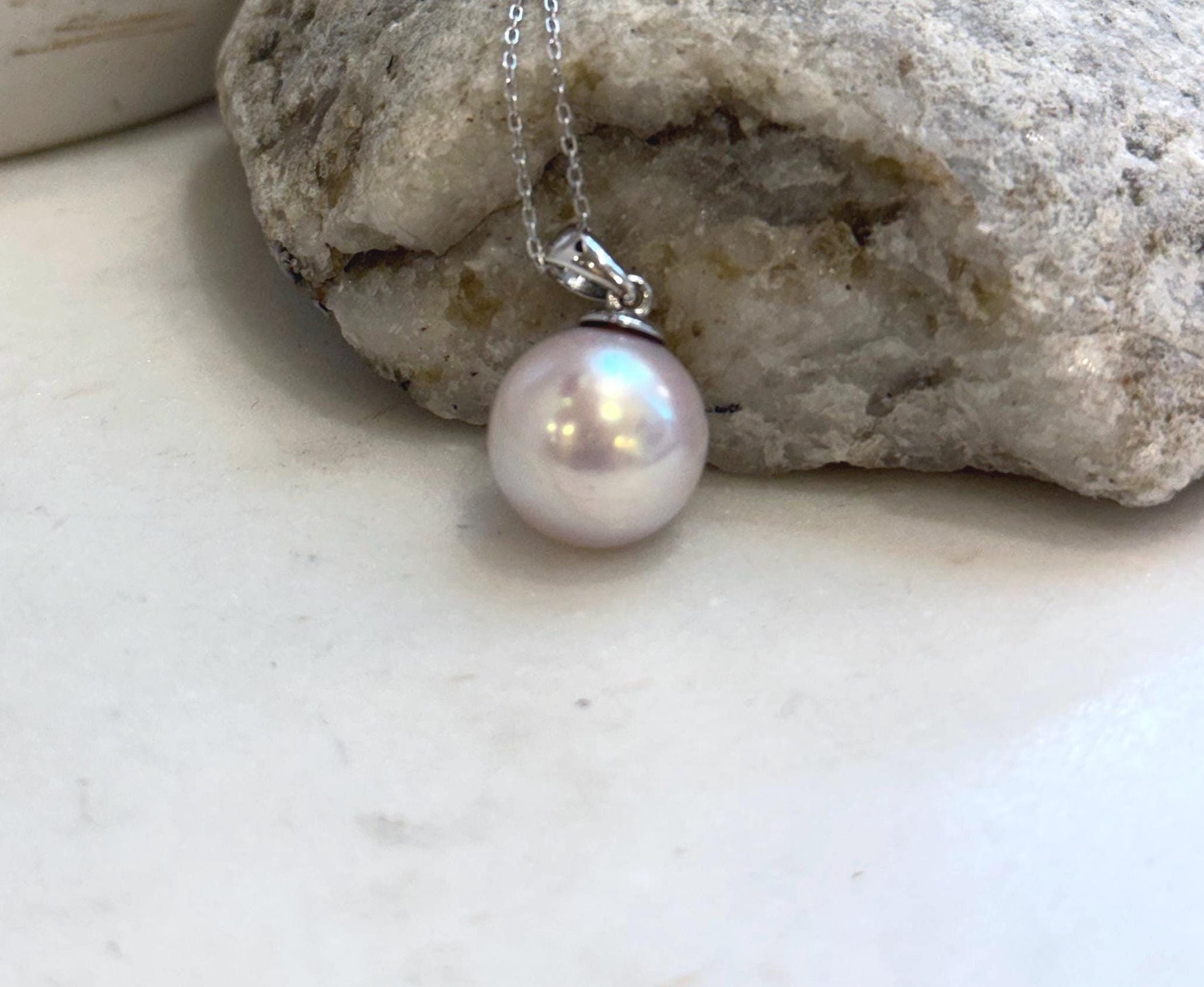 Minimalist Edison pearl necklace pendant with a huge round light rose pearl and sterling silver setting