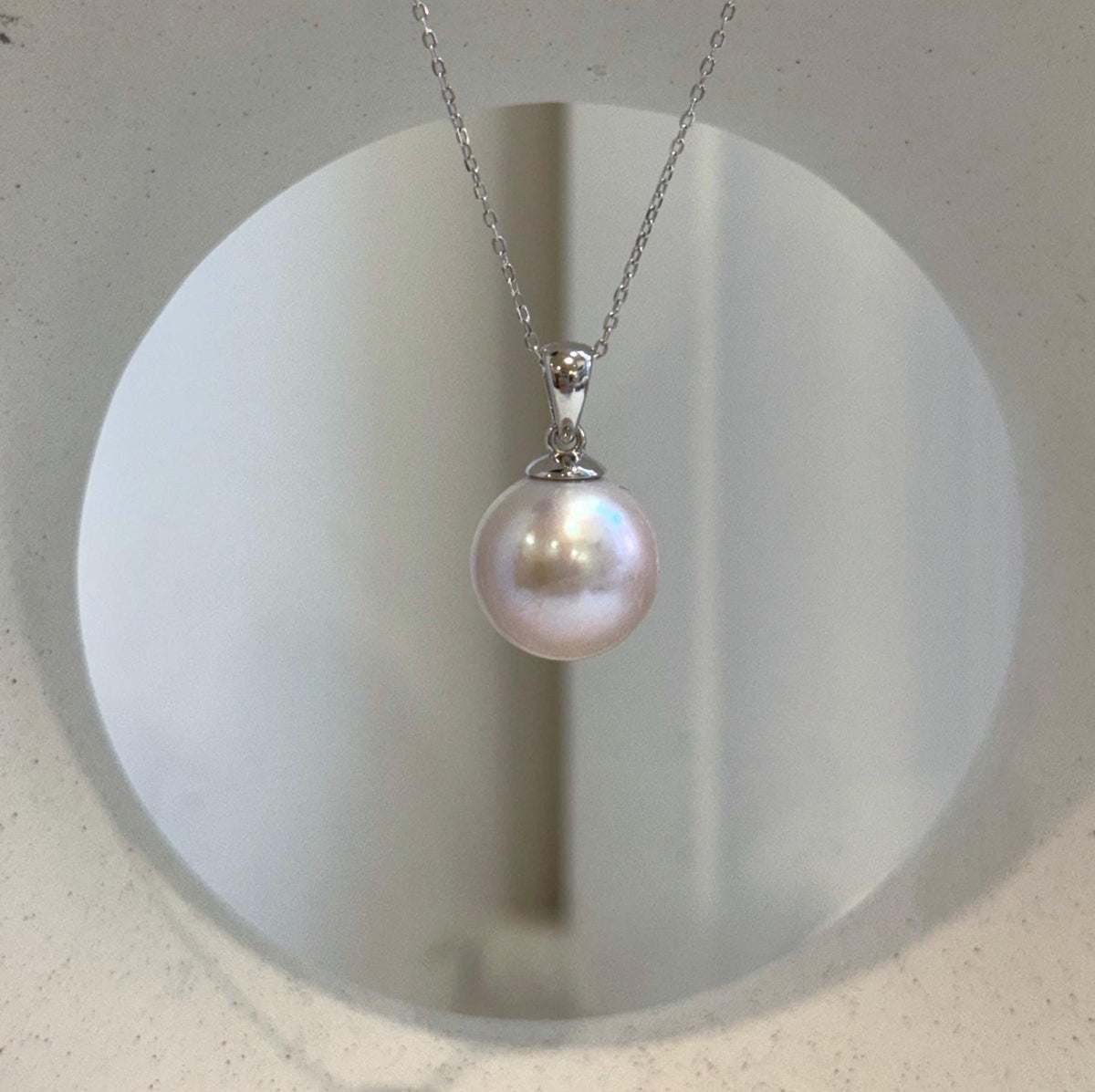 Light rose Edison pearl jewelry featuring a large lustrous pearl with elegant minimalist silver design