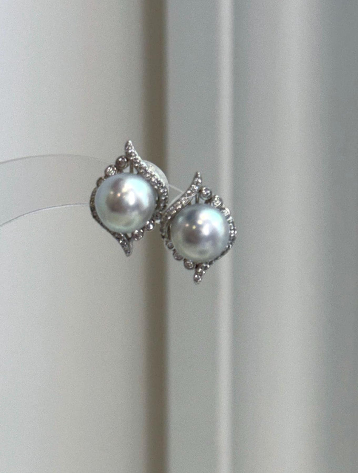 Sophisticated Akoya pearl earrings with cool blue silver color, mirror luster, and delicate silver detailing.