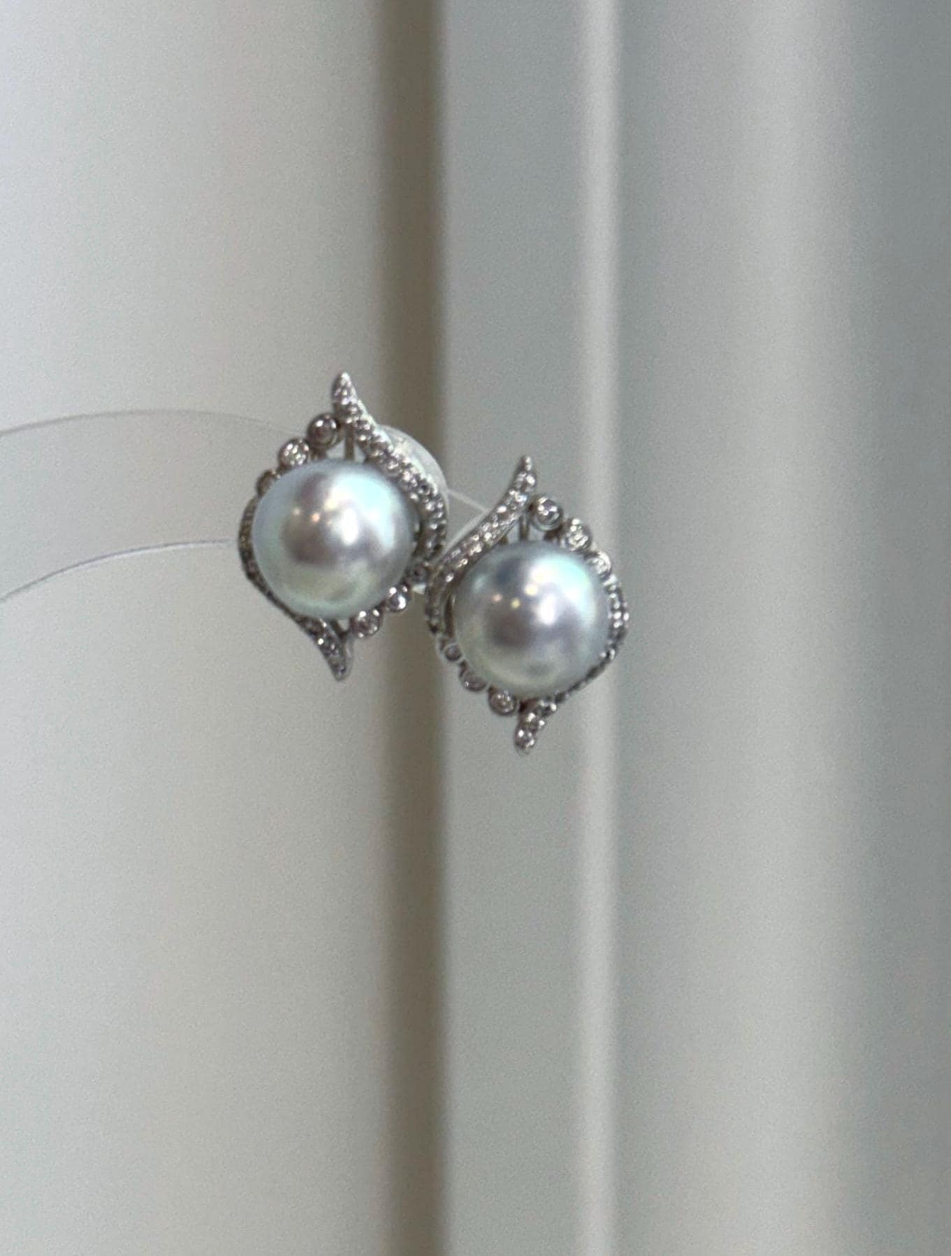 Sophisticated Akoya pearl earrings with cool blue silver color, mirror luster, and delicate silver detailing.