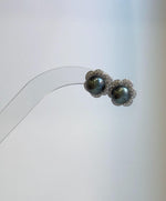 Tahitian hunter pearl stud earrings with deep green overtones, mirror luster and S925 sterling silver floral earring jackets.