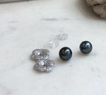 Elegant Tahitian pearl stud earrings with dark hunter green tones and removable sterling silver floral earring jackets.