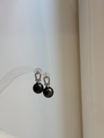 Tahitian black pearl earrings with vivid peacock hunter overtones and smooth high-luster surfaces.