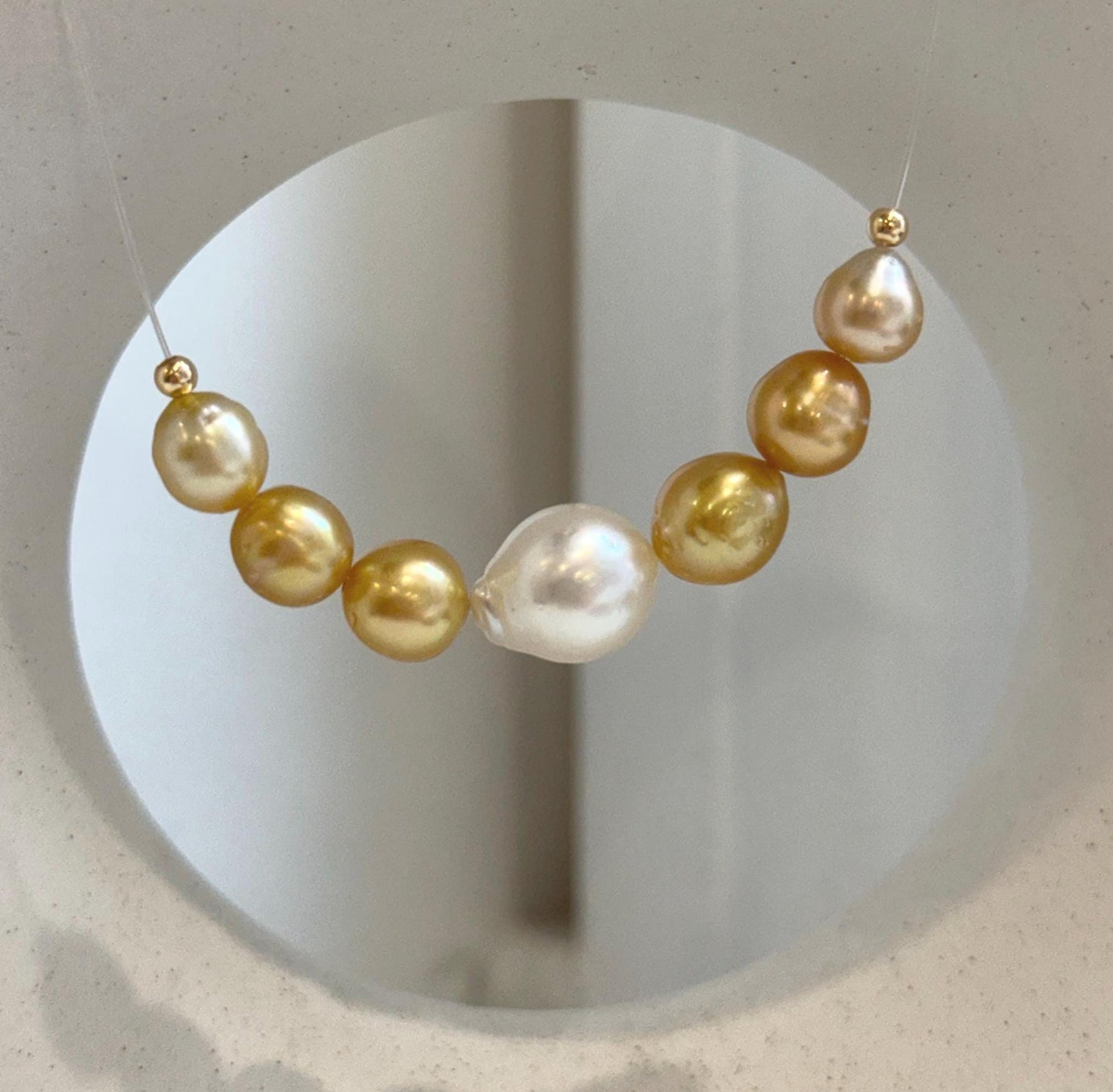 Genuine South Sea ocean pearl necklace featuring 7 lustrous graduated pearls in a classic smile design