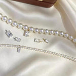 Sparkling clear emerald cut moissanite pendant charm with a minimalist solid 18K gold setting.